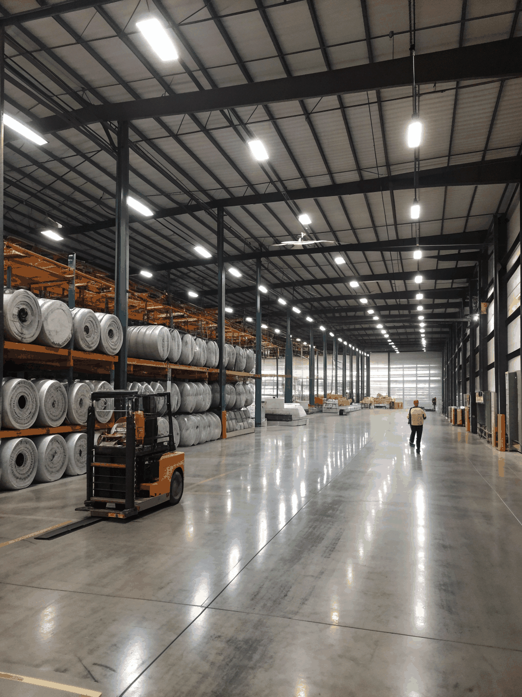 Steel coils being unloaded at a warehouse facility in Orlando